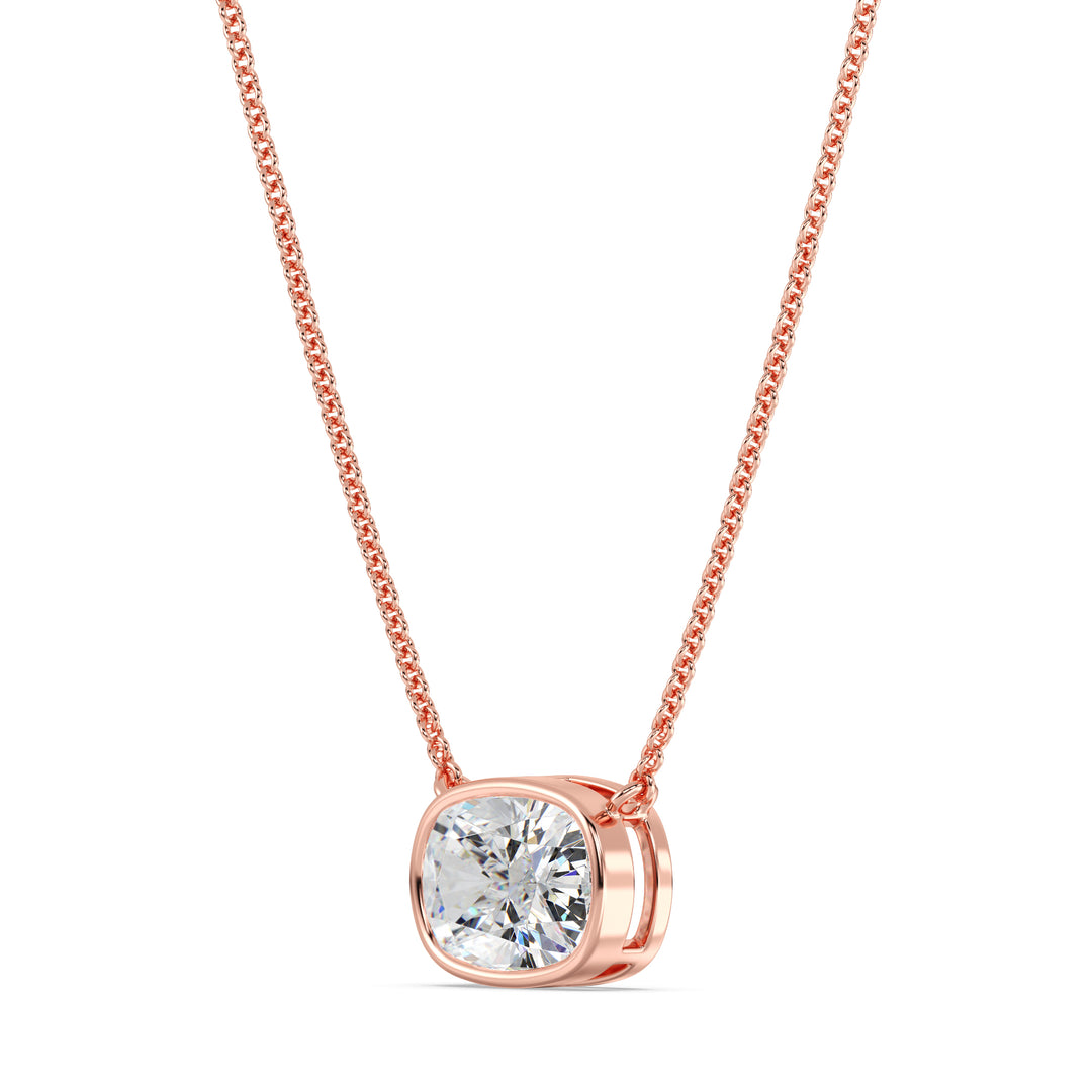 A beautiful 2 Carat Cushion-Cut Lab-Grown Diamond Bezel-Set Solitaire Pendant Necklace in 18K Rose Gold. The romantic pinkish tone enhances the sparkle of the IGI-certified diamond, making it a perfect blend of charm and sophistication.