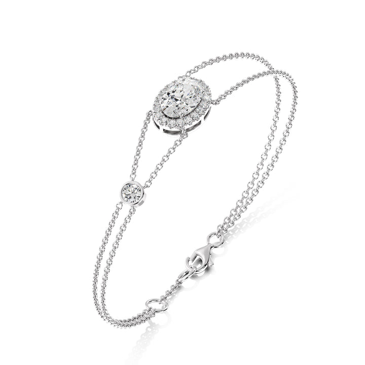 Double Chain 18K White Gold Bracelet with a 1ct Oval-Cut Lab-Grown Diamond in a halo setting, accented by 20 Round-Cut EF/VS Lab-Grown Diamonds for a sleek and timeless design.