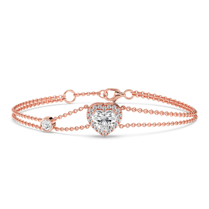 Double-chain bracelet in 18K rose gold with a 1ct heart-cut lab-grown diamond encircled by a halo of 19 round EF/VS lab-grown diamonds, exuding warmth and modern sophistication