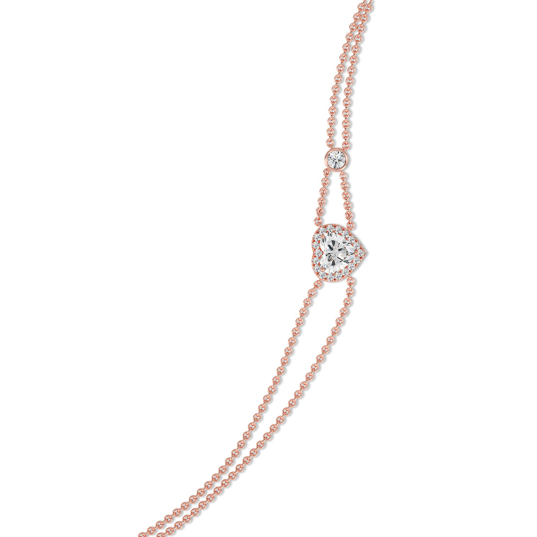 Double-chain bracelet in 18K rose gold with a 1ct heart-cut lab-grown diamond encircled by a halo of 19 round EF/VS lab-grown diamonds, exuding warmth and modern sophistication