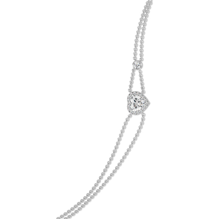 Double-chain bracelet in 18K white gold featuring a 1ct heart-cut lab-grown diamond in a shimmering halo of 19 round EF/VS lab-grown diamonds, offering a sleek and classic look.