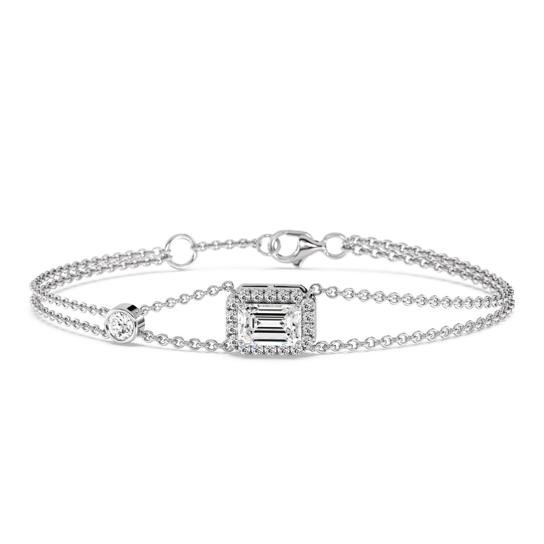 Stylish double-chain bracelet in 18K white gold, highlighted by a 1ct emerald-cut lab-grown diamond surrounded by a halo of 19 round EF/VS lab-grown diamonds.