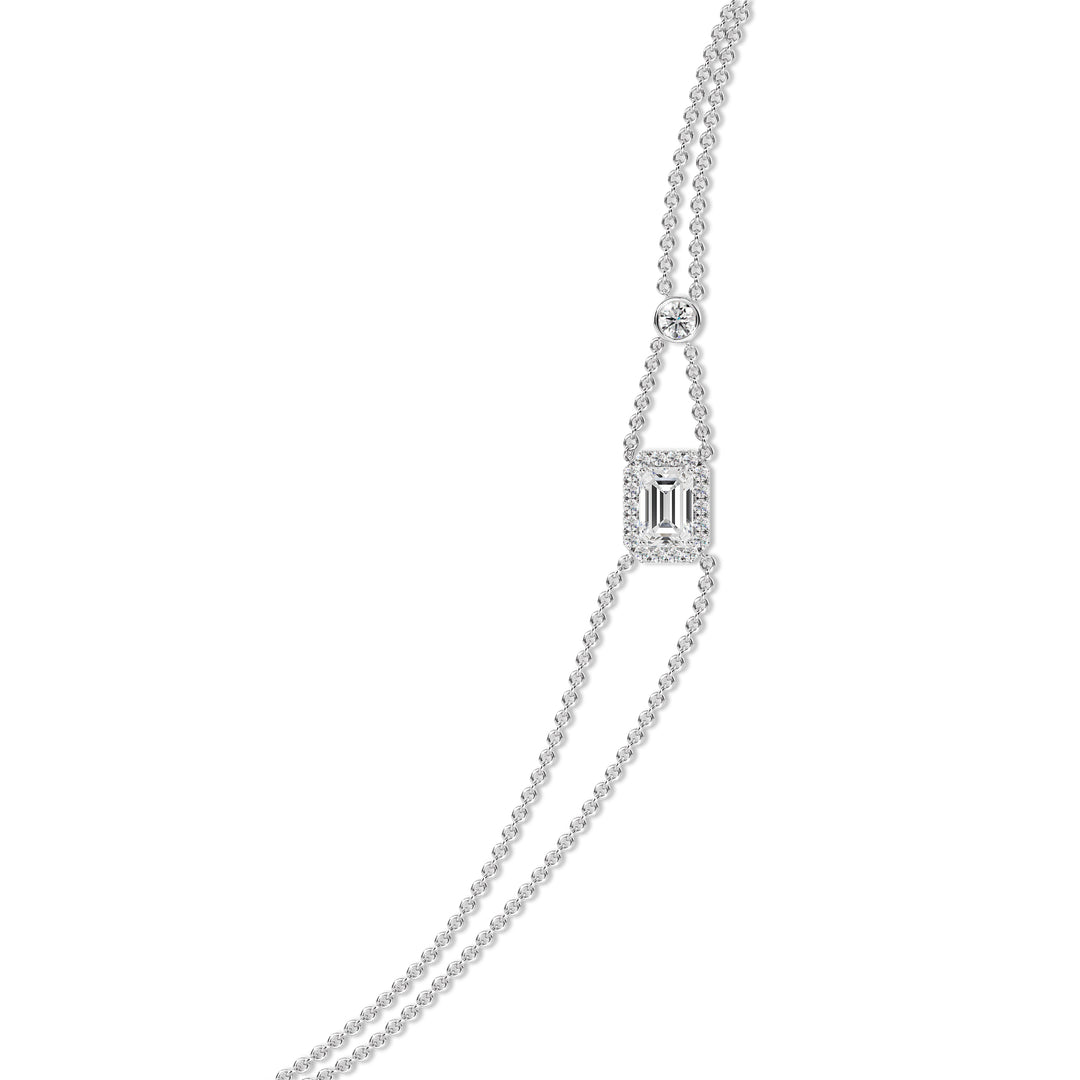 Stylish double-chain bracelet in 18K white gold, highlighted by a 1ct emerald-cut lab-grown diamond surrounded by a halo of 19 round EF/VS lab-grown diamonds.