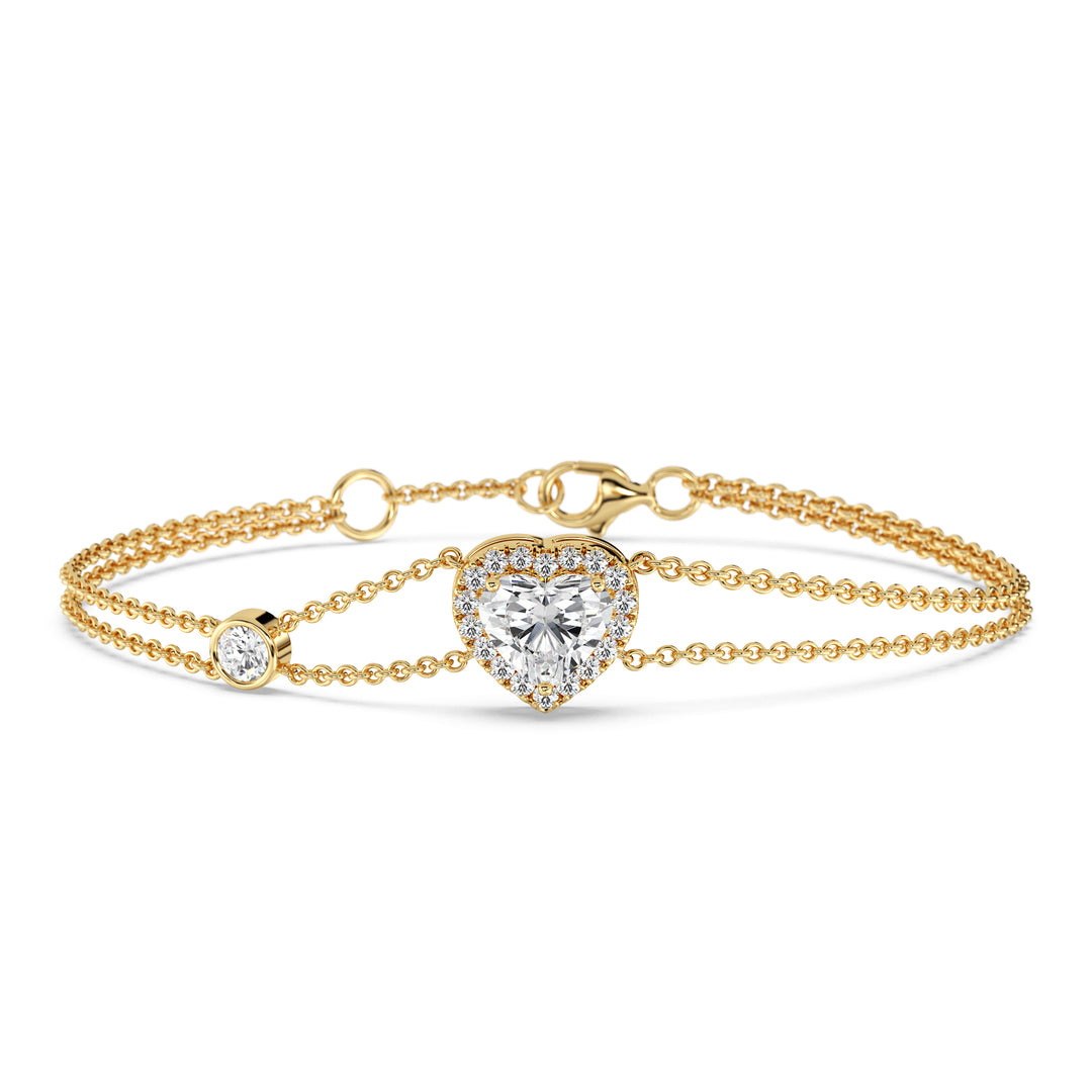 Double-chain bracelet in 18K yellow gold featuring a 1ct heart-cut lab-grown diamond surrounded by a halo of 19 round EF/VS lab-grown diamonds, showcasing timeless elegance and radiant sparkle