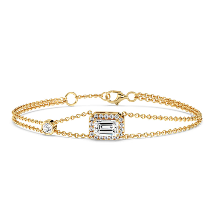 Elegant double-chain bracelet in 18K yellow gold, featuring a 1ct emerald-cut lab-grown diamond in a halo setting with 19 round EF/VS lab-grown diamonds