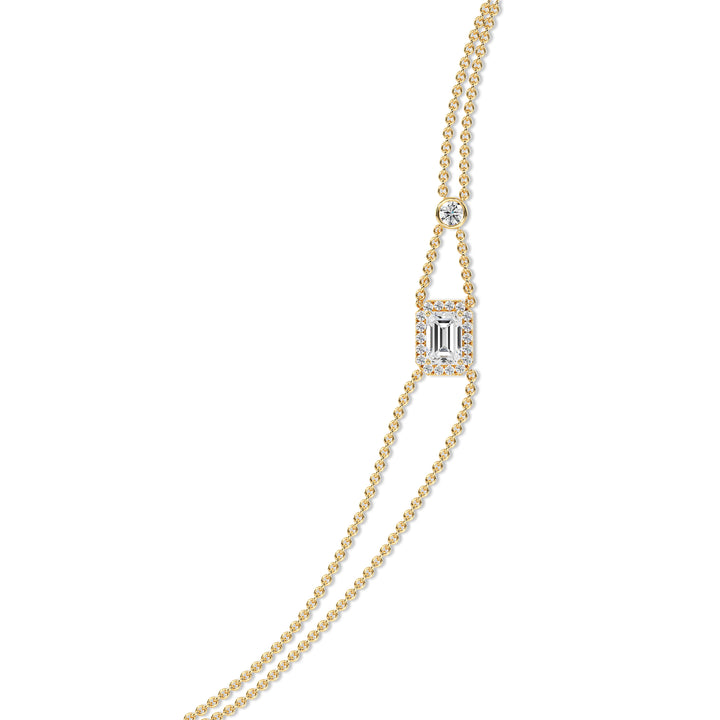 Elegant double-chain bracelet in 18K yellow gold, featuring a 1ct emerald-cut lab-grown diamond in a halo setting with 19 round EF/VS lab-grown diamonds