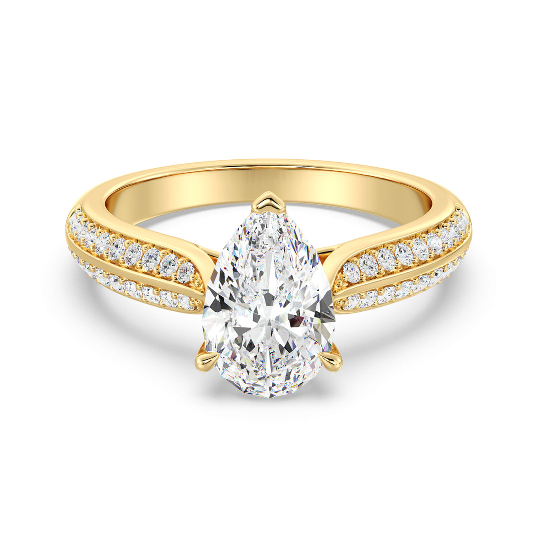 Elegant pear-cut lab-grown diamond engagement ring with pavé band in 18K yellow gold, featuring a brilliant pear-cut center stone and round lab-grown diamonds.