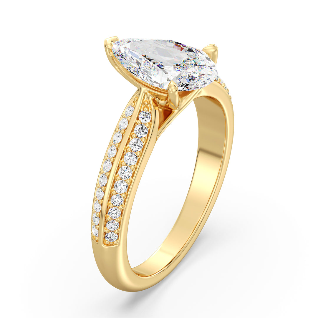 Elegant pear-cut lab-grown diamond engagement ring with pavé band in 18K yellow gold, featuring a brilliant pear-cut center stone and round lab-grown diamonds.