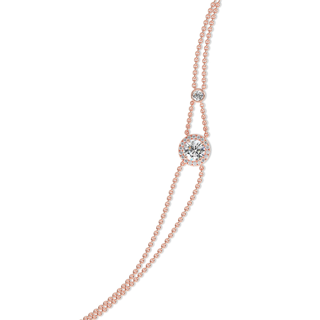 Image of the Halo-Set Round Lab-Grown Diamond Double Chain Bracelet in 18K Rose Gold, showcasing a 1ct round-cut lab-grown diamond encircled by a halo of 19 smaller diamonds, complemented by a modern double-chain design.