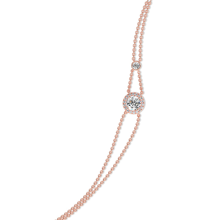 Image of the Halo-Set Round Lab-Grown Diamond Double Chain Bracelet in 18K Rose Gold, showcasing a 1ct round-cut lab-grown diamond encircled by a halo of 19 smaller diamonds, complemented by a modern double-chain design.