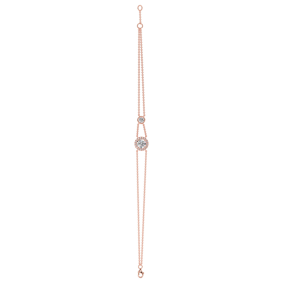 Image of the Halo-Set Round Lab-Grown Diamond Double Chain Bracelet in 18K Rose Gold, showcasing a 1ct round-cut lab-grown diamond encircled by a halo of 19 smaller diamonds, complemented by a modern double-chain design.