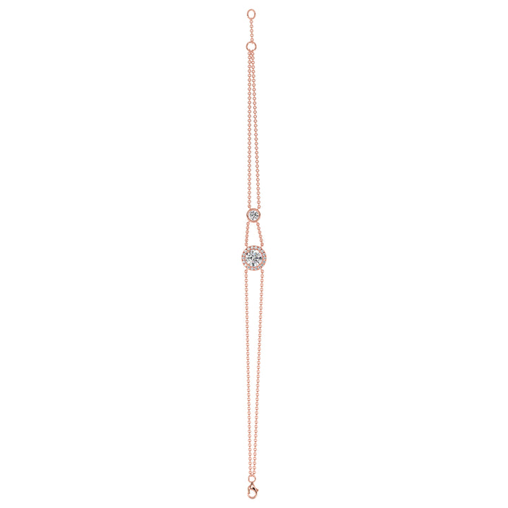 Image of the Halo-Set Round Lab-Grown Diamond Double Chain Bracelet in 18K Rose Gold, showcasing a 1ct round-cut lab-grown diamond encircled by a halo of 19 smaller diamonds, complemented by a modern double-chain design.