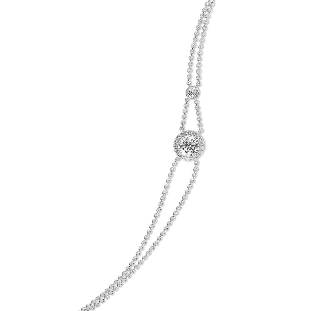 Image of the Halo-Set Round Lab-Grown Diamond Double Chain Bracelet in 18K White Gold, highlighting a 1ct round-cut lab-grown diamond framed by a halo of 19 smaller diamonds, paired with an elegant double-chain design.