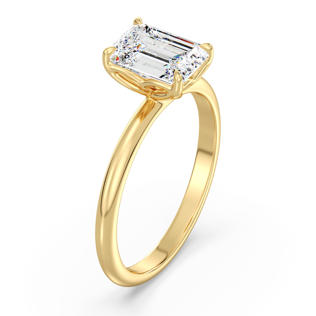 Classic emerald-cut solitaire engagement ring with a 4-claw lab-grown diamond in 18K yellow gold, showcasing timeless elegance and brilliance