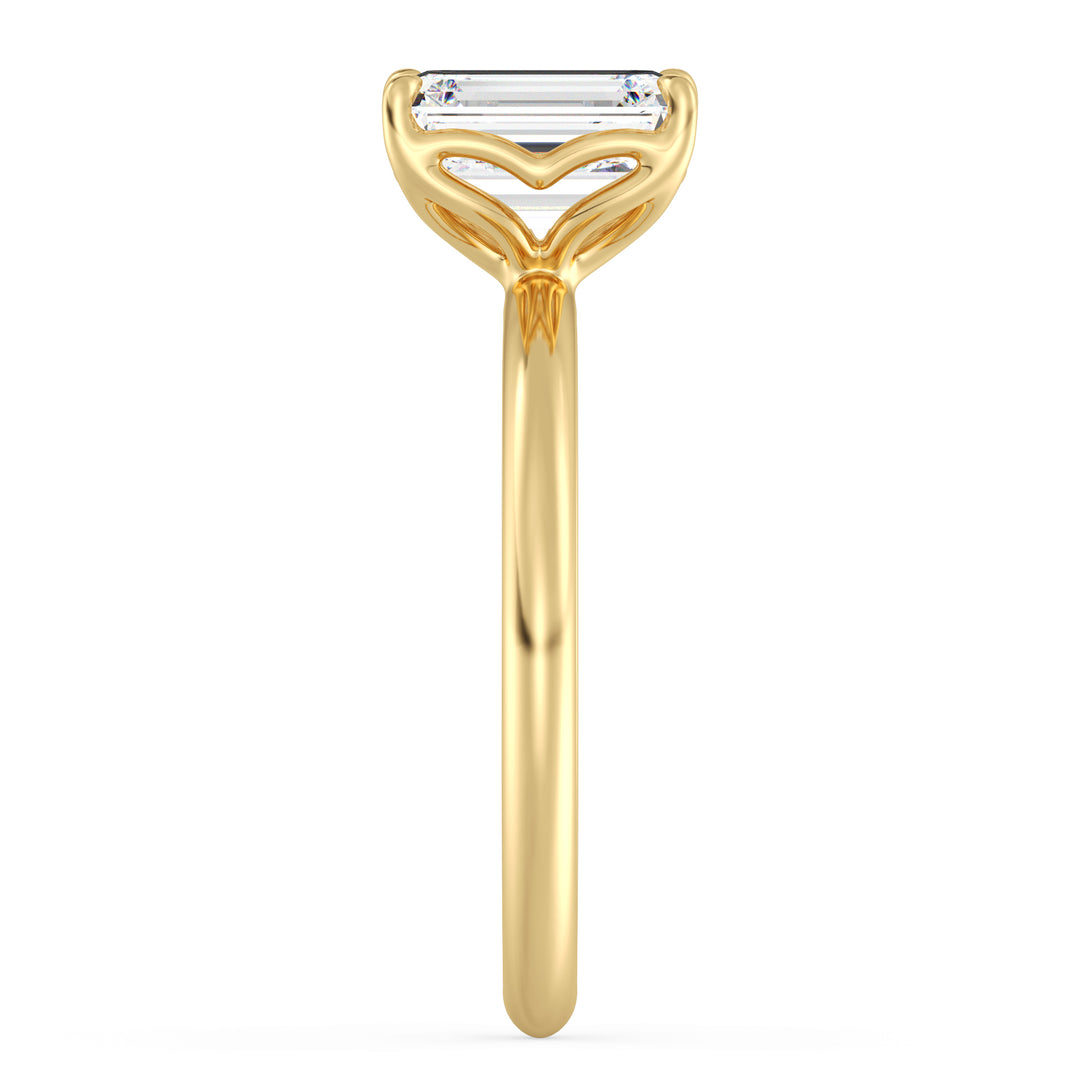 Classic emerald-cut solitaire engagement ring with a 4-claw lab-grown diamond in 18K yellow gold, showcasing timeless elegance and brilliance