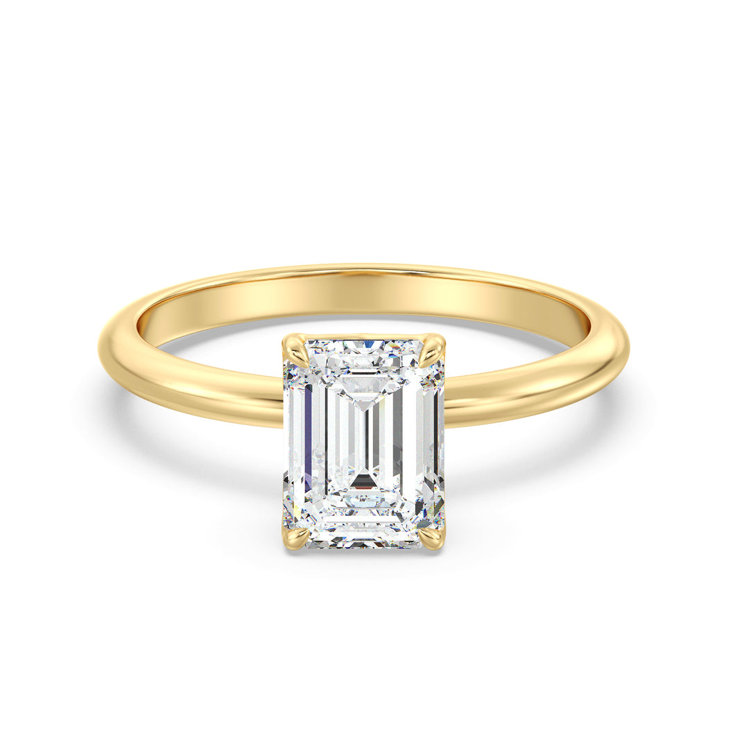 Classic emerald-cut solitaire engagement ring with a 4-claw lab-grown diamond in 18K yellow gold, showcasing timeless elegance and brilliance