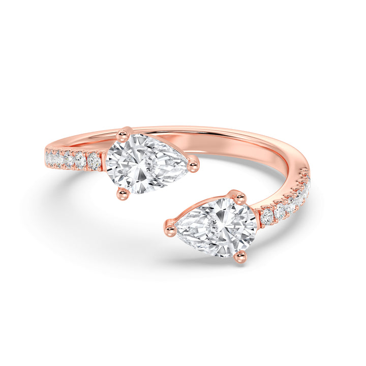 A stunning IGI Certified Pear-Shaped Lab-Grown Diamond Open Cuff Ring in 18K rose gold, showcasing two pear-cut diamonds and round brilliant-cut accent diamonds, blending elegance with modern charm.
