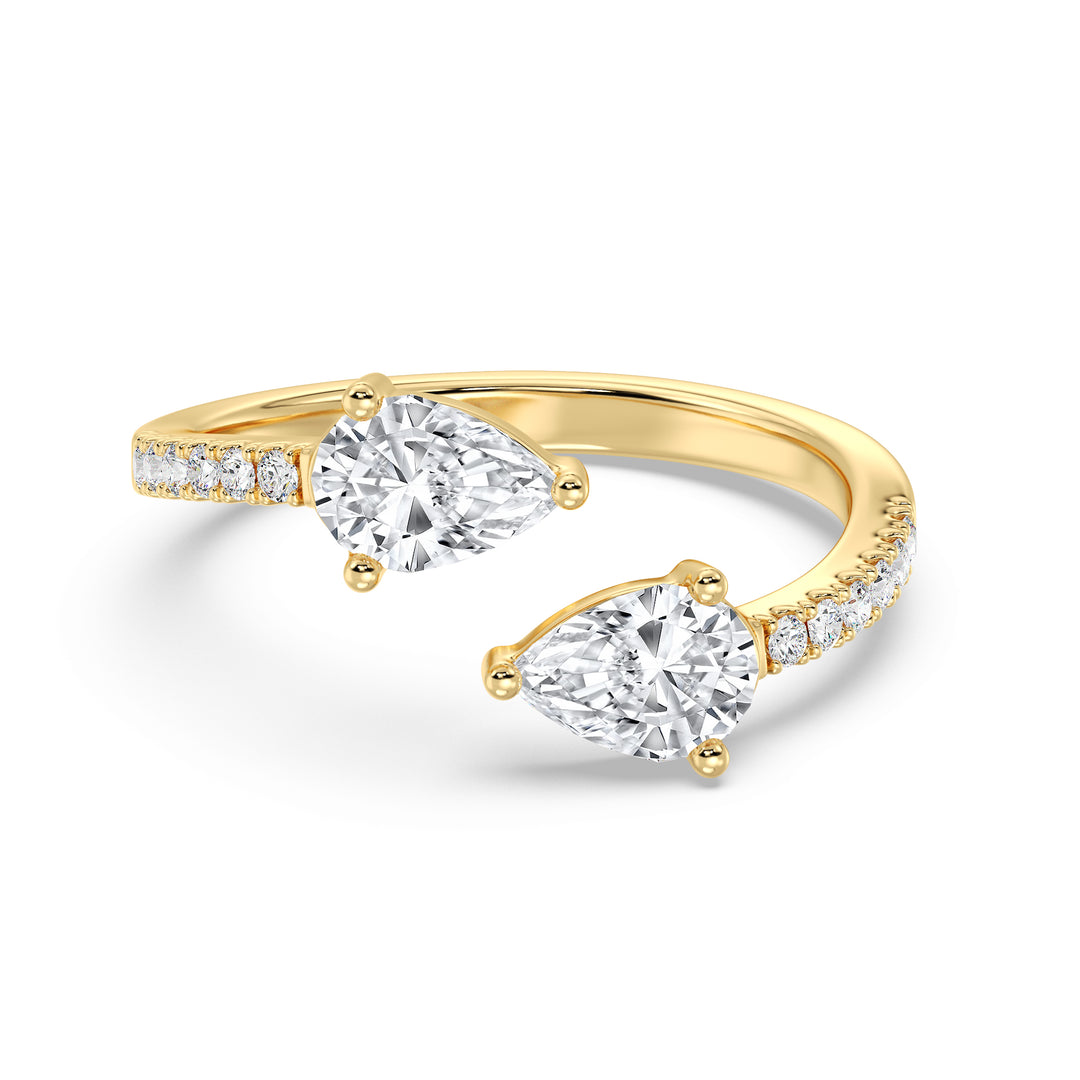 A beautifully crafted IGI Certified Pear-Shaped Lab-Grown Diamond Open Cuff Ring in 18K yellow gold, featuring two pear-cut diamonds and round brilliant-cut accent diamonds for a luxurious and sophisticated look.