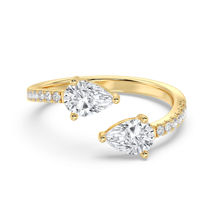 A beautifully crafted IGI Certified Pear-Shaped Lab-Grown Diamond Open Cuff Ring in 18K yellow gold, featuring two pear-cut diamonds and round brilliant-cut accent diamonds for a luxurious and sophisticated look.