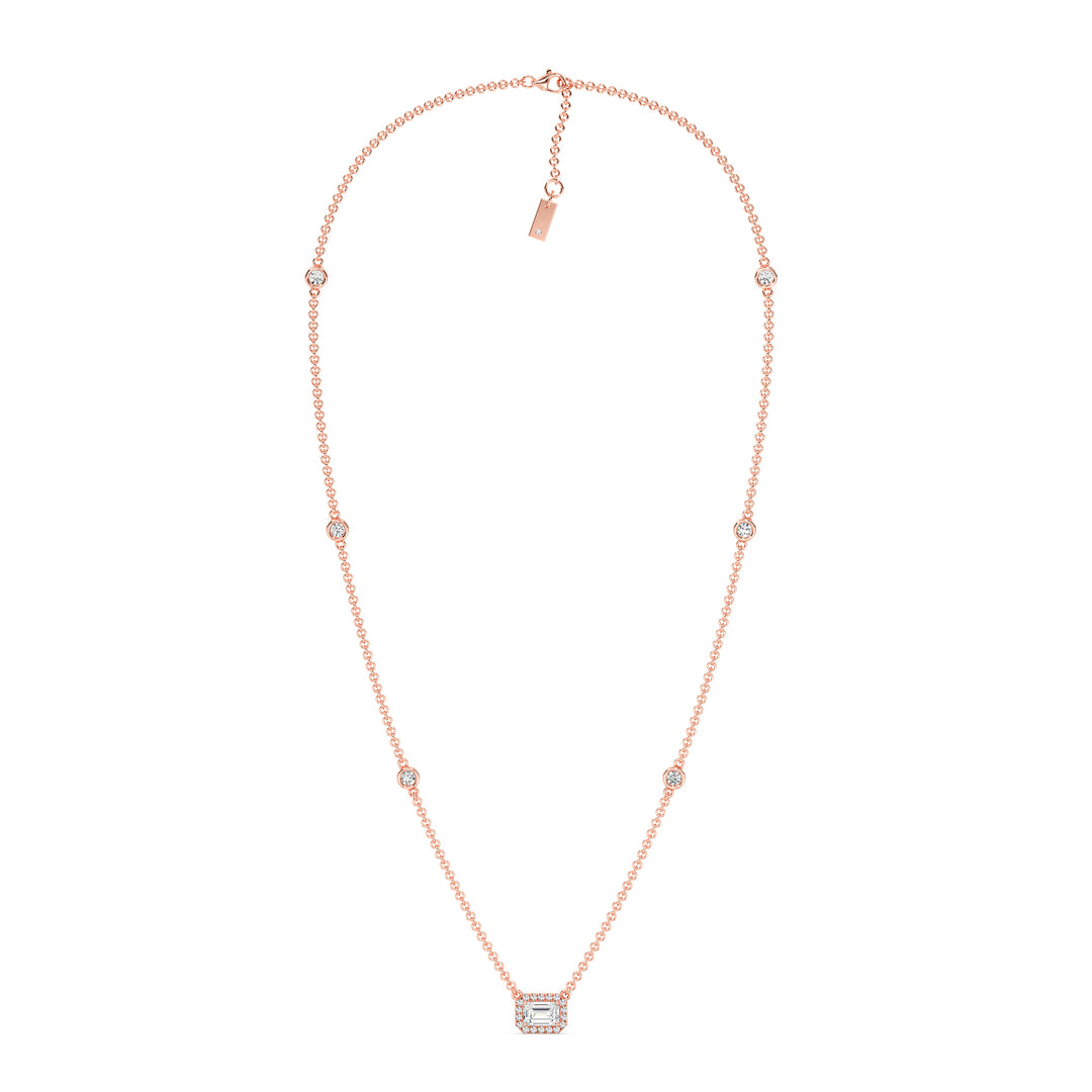 Elegant Emerald-Cut Lab-Grown Diamond Station Necklace in 18K Rose Gold showcasing a bezel-set 1.00-carat emerald-cut diamond with halo and stationed round diamonds for added brilliance.