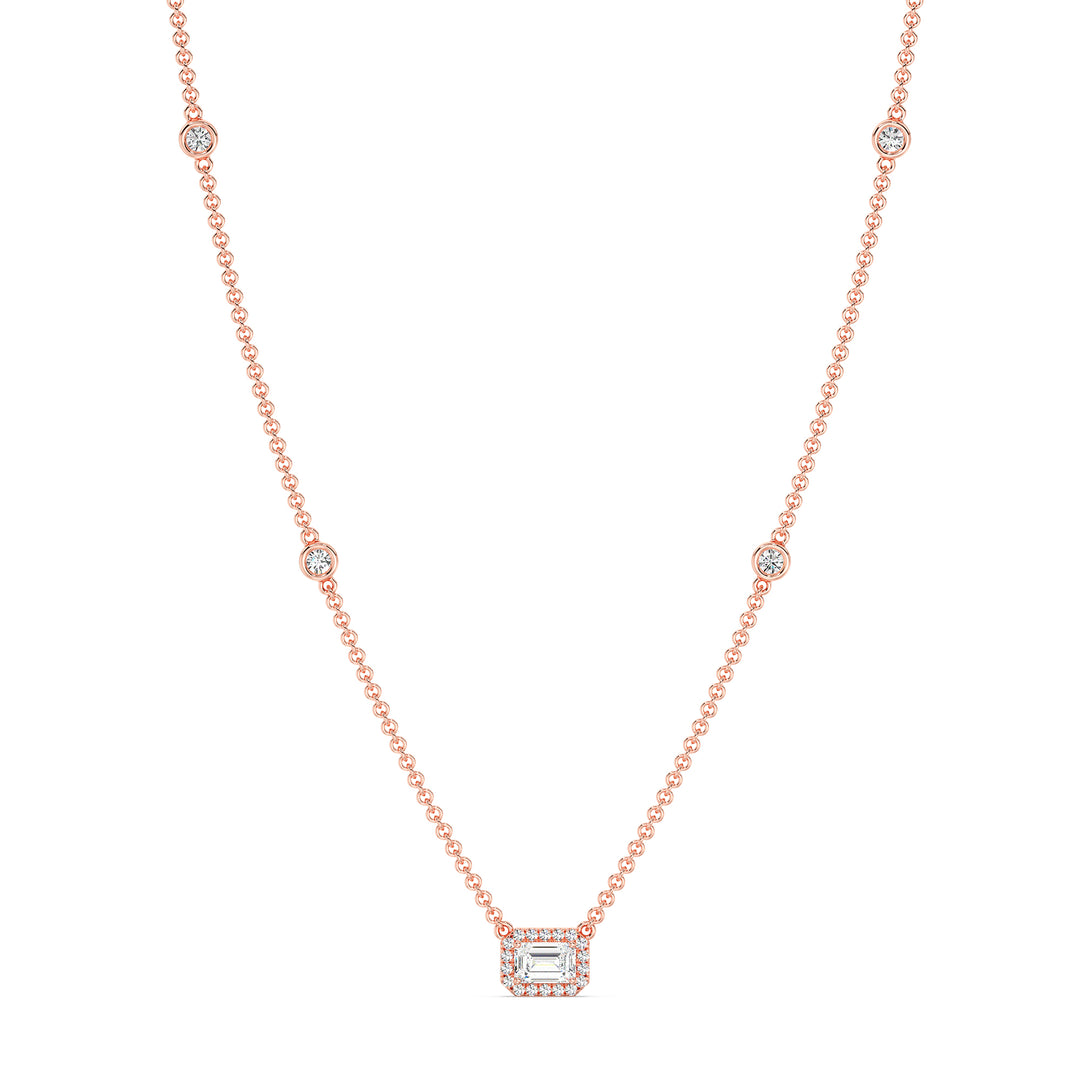 Elegant Emerald-Cut Lab-Grown Diamond Station Necklace in 18K Rose Gold showcasing a bezel-set 1.00-carat emerald-cut diamond with halo and stationed round diamonds for added brilliance.