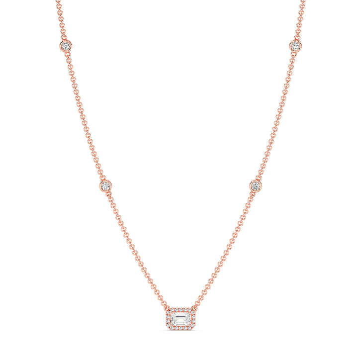 Elegant Emerald-Cut Lab-Grown Diamond Station Necklace in 18K Rose Gold showcasing a bezel-set 1.00-carat emerald-cut diamond with halo and stationed round diamonds for added brilliance.