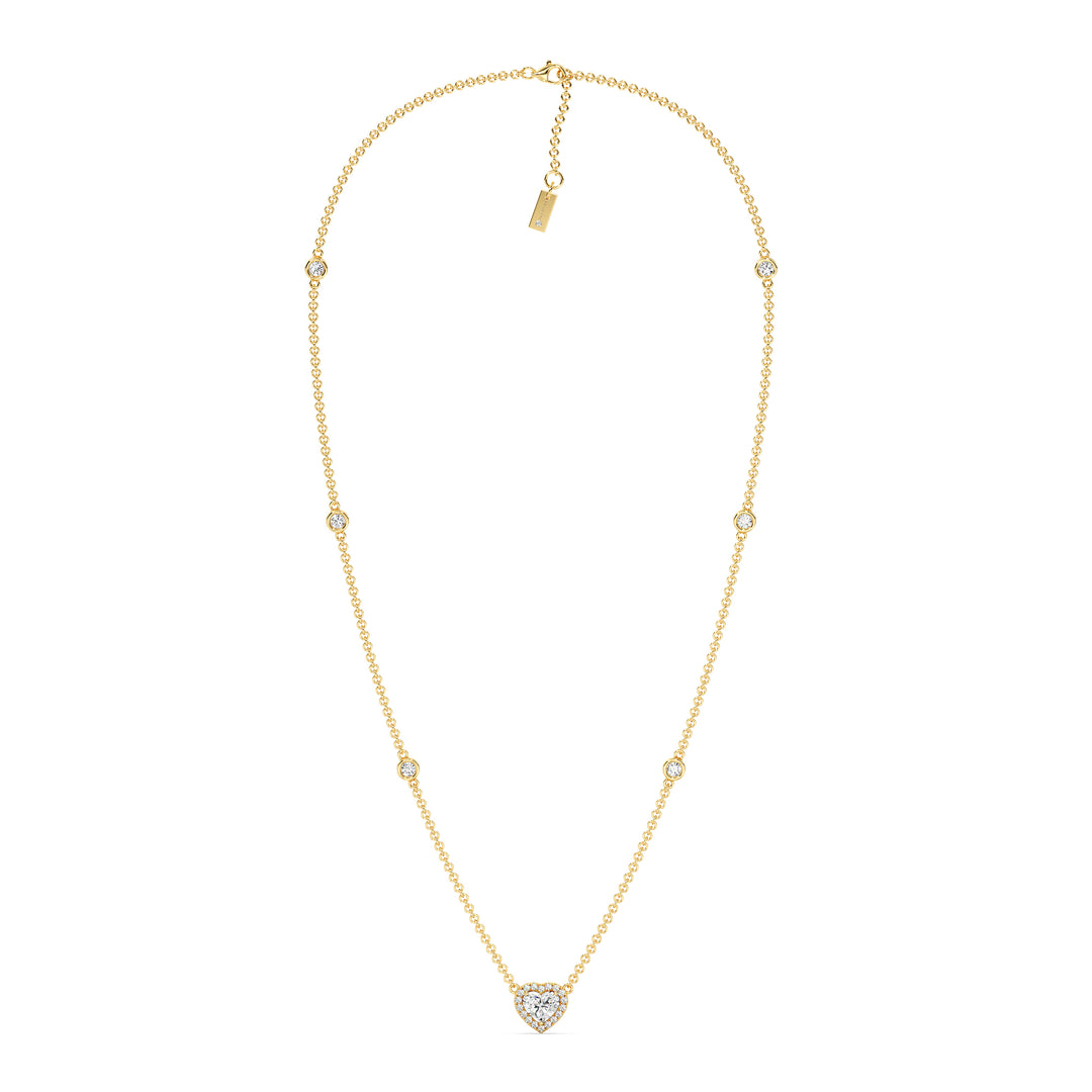 Elegant Heart Diamond Accent Halo & Bezel Station Necklace in 18K Yellow Gold featuring a 1.00ct heart-cut lab-grown diamond surrounded by a halo of smaller EF/VS diamonds and a bezel-set diamond-accented chain