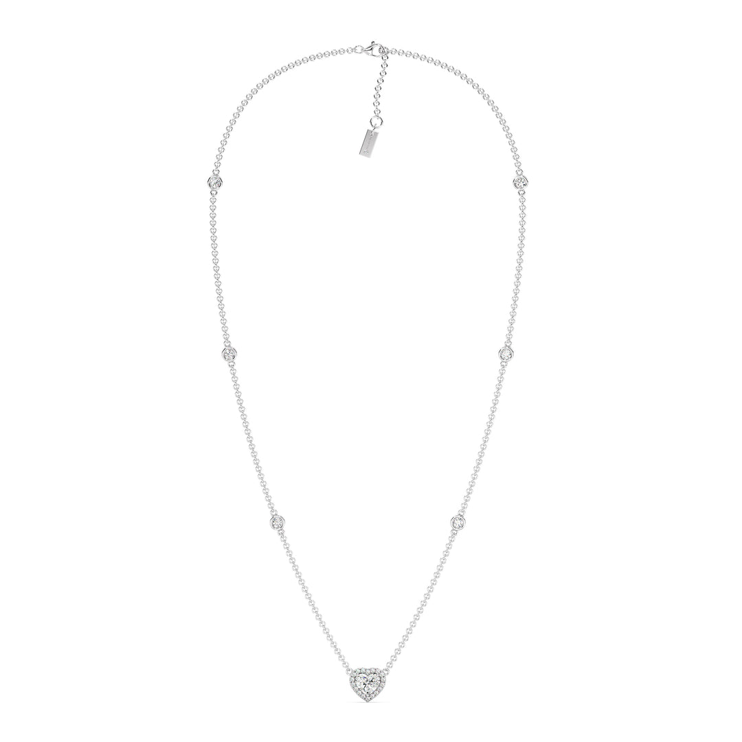 Elegant Heart Diamond Accent Halo & Bezel Station Necklace in 18K White Gold with a central 1.00ct heart-cut lab-grown diamond surrounded by a halo of smaller EF/VS diamonds and a bezel-set diamond-accented chain.
