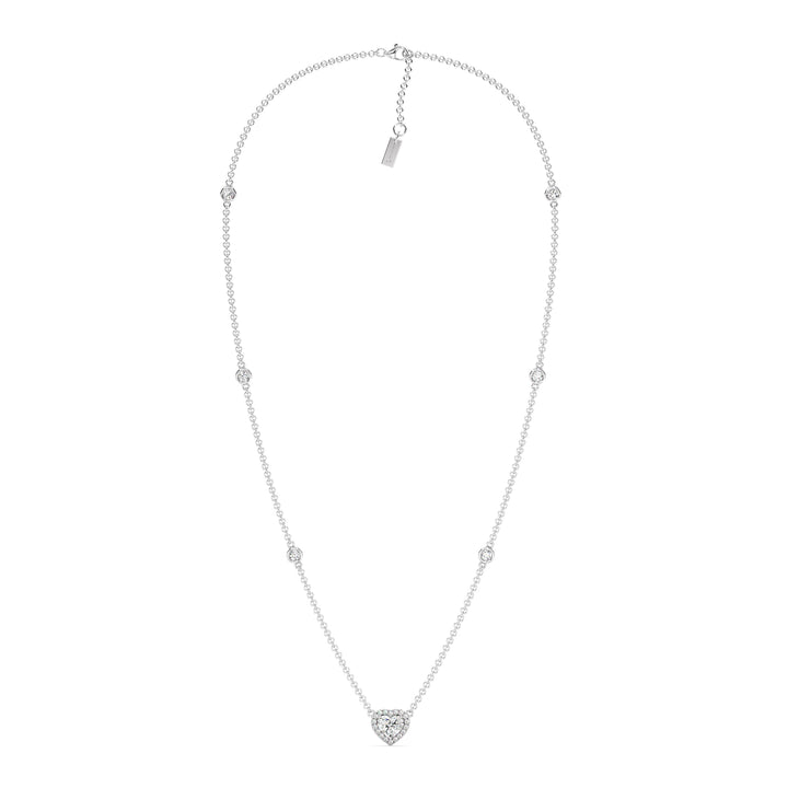 Elegant Heart Diamond Accent Halo & Bezel Station Necklace in 18K White Gold with a central 1.00ct heart-cut lab-grown diamond surrounded by a halo of smaller EF/VS diamonds and a bezel-set diamond-accented chain.