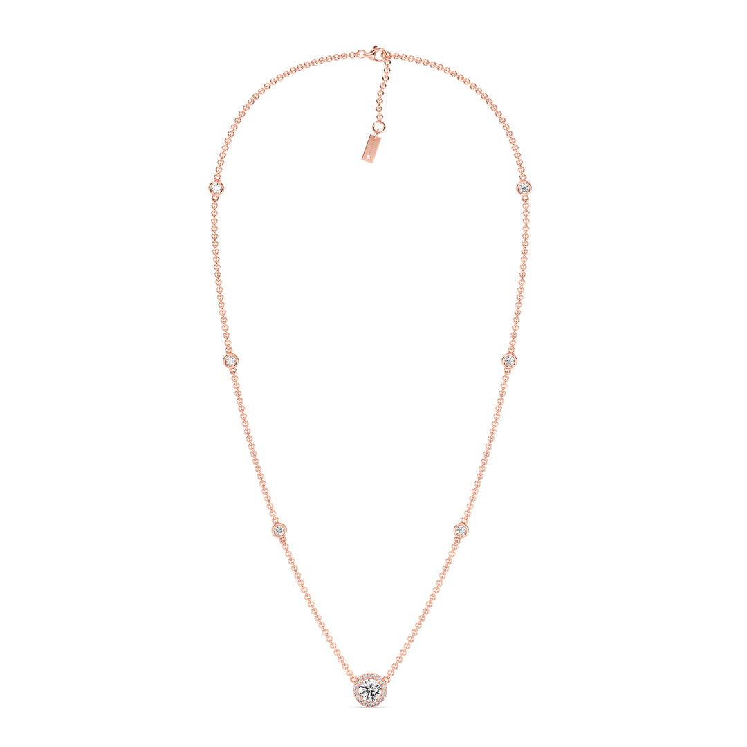 18K rose gold Round Diamond Accent Halo Bezel Station Necklace with a 1.00ct IGI Certified lab-grown diamond at the center, surrounded by EF/VS halo diamonds and bezel-set diamonds along the chain