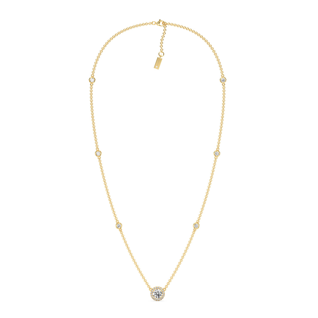 18K yellow gold Round Diamond Accent Halo Bezel Station Necklace featuring a 1.00ct IGI Certified lab-grown diamond at the center with a halo of smaller EF/VS diamonds and additional bezel-set diamonds on the chain