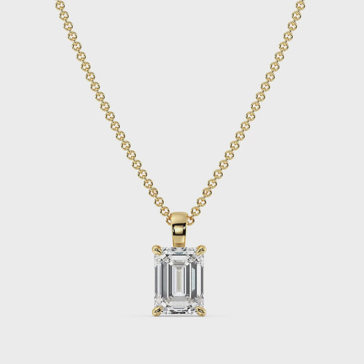 Video showcasing the Elegant Emerald-Cut Lab-Grown Diamond Solitaire Pendant in 18K Yellow Gold, featuring a stunning emerald-cut diamond in a classic 4-prong setting, highlighting its brilliance and timeless elegance.