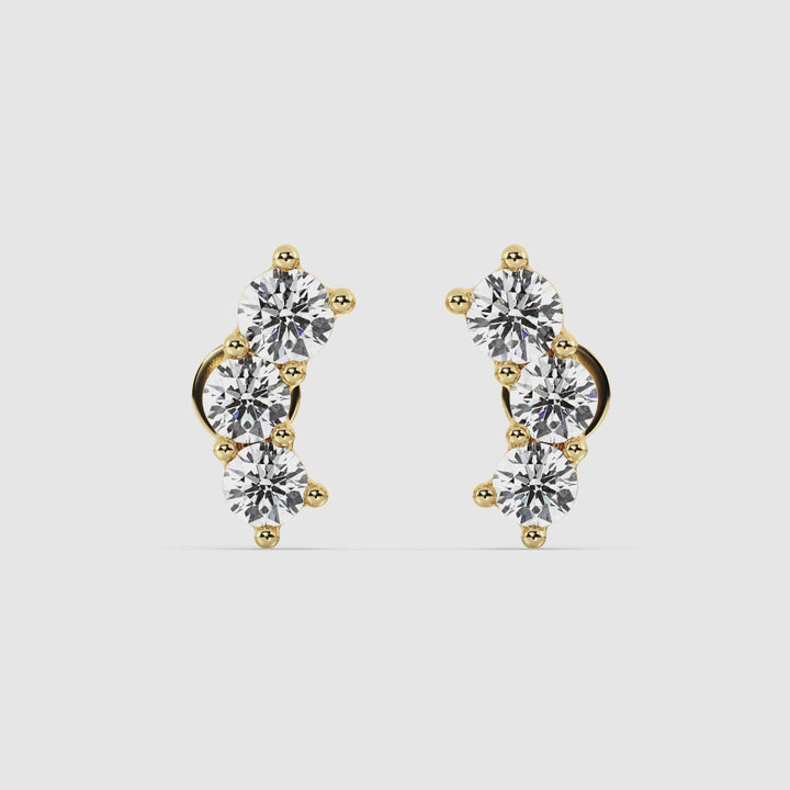 Close-up video of elegant 18K Yellow Gold Curved Three-Stone Stud Earrings, featuring 0.76 Ct of EF/VS round lab-grown diamonds, showcasing the unique curved design and secure back closure