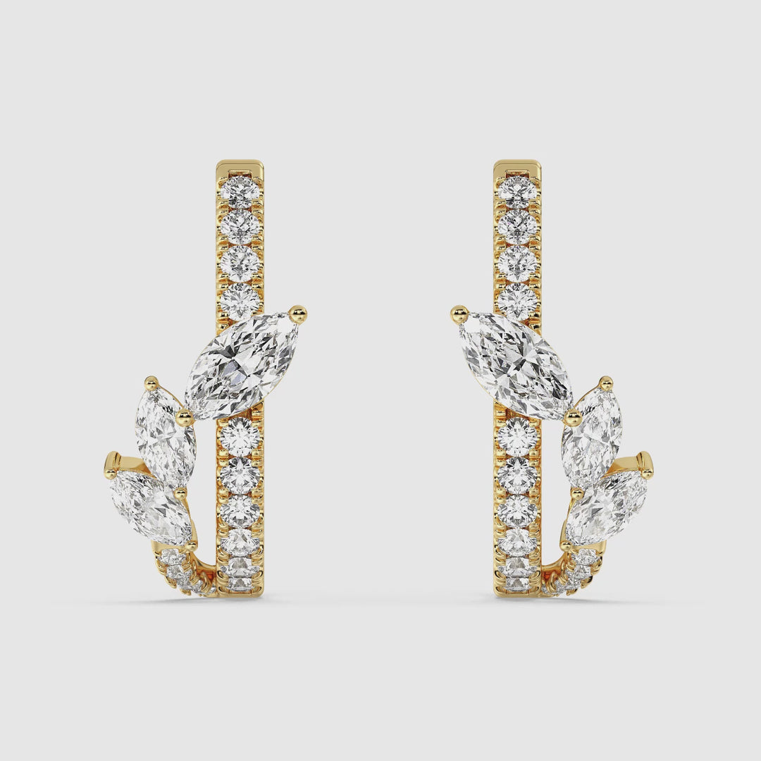Close-up video showcasing the Yellow Gold variant of elegant 18K Gold Twist Hoop Earrings. The hoops feature a stunning twist design adorned with marquise and round lab-grown diamonds, exuding a radiant sparkle. The secure clasp and fine craftsmanship are highlighted as the earrings rotate, revealing their exceptional detail and luxurious finish