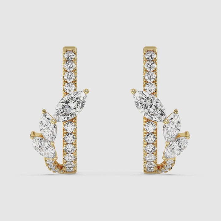 Close-up video showcasing the Yellow Gold variant of elegant 18K Gold Twist Hoop Earrings. The hoops feature a stunning twist design adorned with marquise and round lab-grown diamonds, exuding a radiant sparkle. The secure clasp and fine craftsmanship are highlighted as the earrings rotate, revealing their exceptional detail and luxurious finish