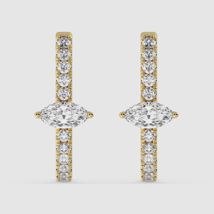 Close-up video showcasing the Yellow Gold variant of the 18K Gold Triple Hoop Huggie Earrings, adorned with shimmering lab-grown diamonds. The intricate design highlights pear and round-cut diamonds set in three elegant hoops, capturing their radiant sparkle from multiple angles. The lightweight and luxurious earrings are displayed to emphasize their craftsmanship, timeless beauty, and comfortable fit