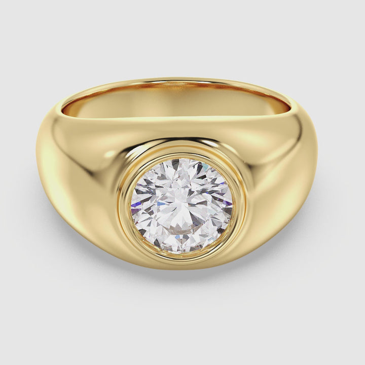 A close-up video showcasing an IGI Certified 2ctw Round Lab-Grown Diamond Men's Signet Ring in 18K Yellow Gold. The sleek bezel setting securely holds the brilliant diamond, highlighting its exceptional EF color grade and VS clarity. The rich, warm tone of the yellow gold band adds a timeless elegance, making this ring a bold and sophisticated statement piece for any occasion.