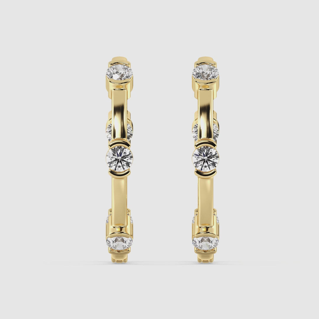 Close-up video of 18K Yellow Gold Hoop Earrings featuring 1.10 Ct EF/VS round lab-grown diamonds. The video showcases the earrings' elegant design, secure clasp closure, and brilliant sparkle as they catch the light, highlighting the luxurious craftsmanship and sustainable materials