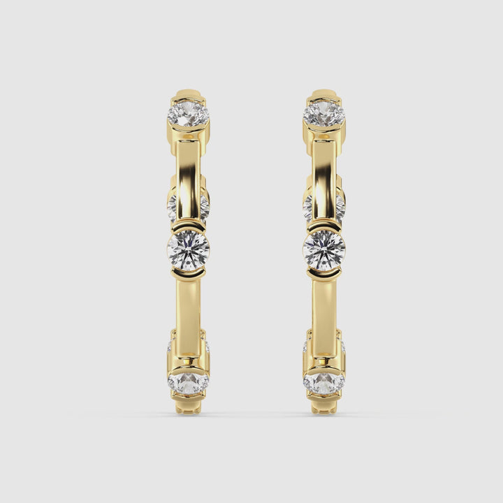 Close-up video of 18K Yellow Gold Hoop Earrings featuring 1.10 Ct EF/VS round lab-grown diamonds. The video showcases the earrings' elegant design, secure clasp closure, and brilliant sparkle as they catch the light, highlighting the luxurious craftsmanship and sustainable materials