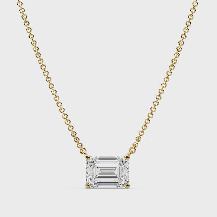 ideo showcasing a 2.00 Carat Lab-Grown Emerald-Cut Diamond Solitaire Pendant Necklace in 18K Yellow Gold. The pendant features a dazzling emerald-cut diamond in a classic prong setting, suspended from a sleek yellow gold chain. The video highlights the pendant's brilliance, clarity, and exceptional craftsmanship, making it a timeless and elegant accessory
