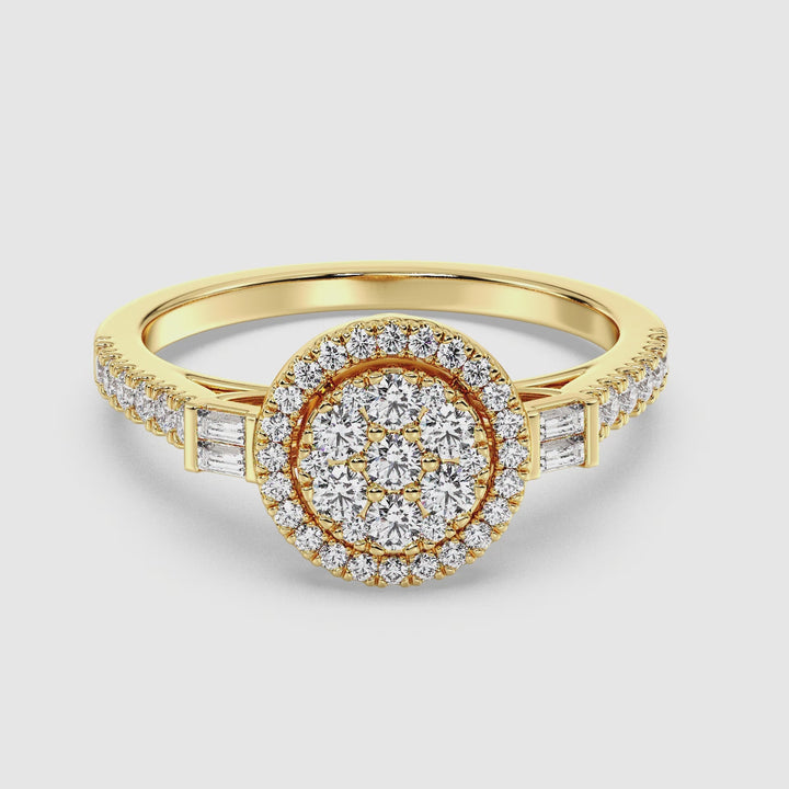 A close-up video showcasing the Yellow Gold variant of a 0.74 CTTW Lab-Grown Diamond Round Cluster Halo Engagement Ring. The dazzling EF color diamonds with VS clarity sparkle brilliantly in the light, arranged in a round cluster halo design. The warm, radiant 18K Yellow Gold band enhances the elegance of the diamonds, highlighting the intricate craftsmanship and luxurious appeal of the ring. Perfect for proposals, this ring symbolizes timeless love and sustainability.