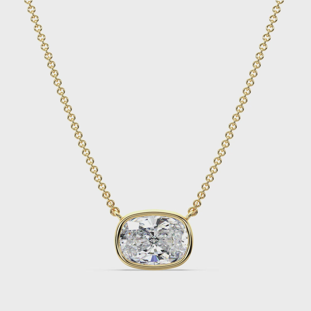 A close-up video showcasing a stunning 2 Carat Cushion-Cut Lab-Grown Diamond Bezel-Set Solitaire Pendant Necklace in Yellow Gold. The pendant features a brilliant IGI-certified diamond with E color grade and VS clarity, securely encased in a sleek bezel setting. The 18K Yellow Gold shines with a warm, luxurious glow, complemented by a delicately crafted matching chain. The video highlights the pendant's intricate craftsmanship, radiant sparkle, and elegant design from various angles, emphasizing its timeles
