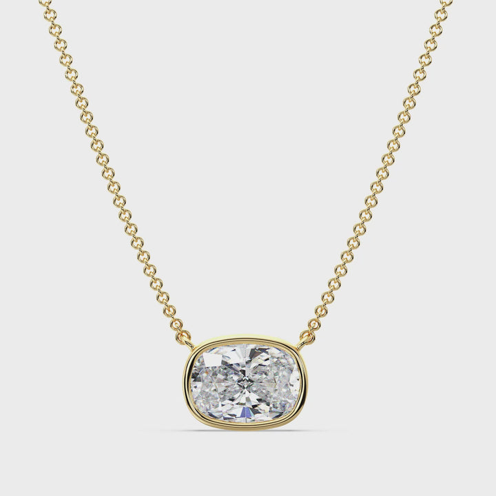 A close-up video showcasing a stunning 2 Carat Cushion-Cut Lab-Grown Diamond Bezel-Set Solitaire Pendant Necklace in Yellow Gold. The pendant features a brilliant IGI-certified diamond with E color grade and VS clarity, securely encased in a sleek bezel setting. The 18K Yellow Gold shines with a warm, luxurious glow, complemented by a delicately crafted matching chain. The video highlights the pendant's intricate craftsmanship, radiant sparkle, and elegant design from various angles, emphasizing its timeles