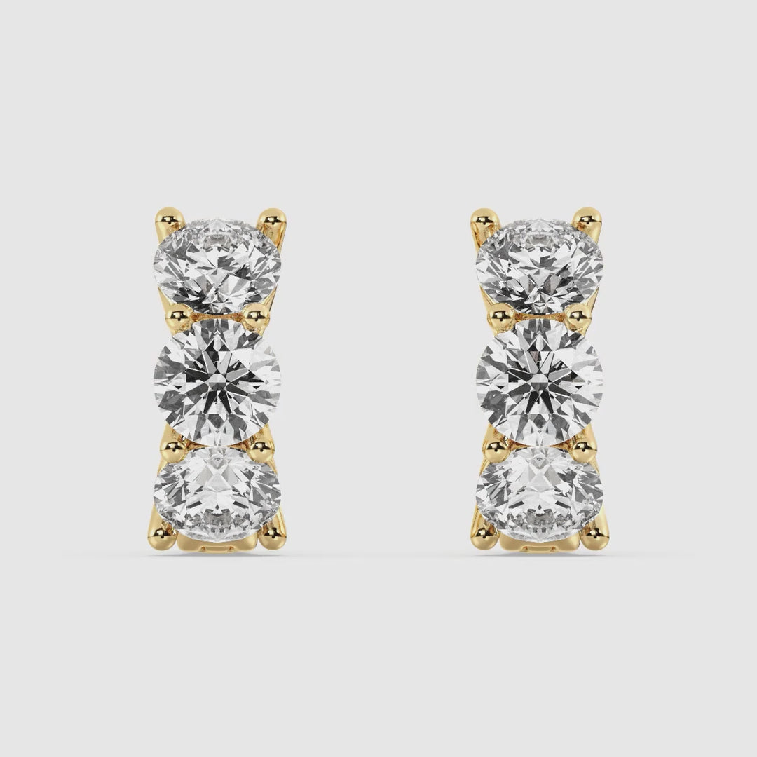 Video showcasing 18K Yellow Gold Huggie Hoop Earrings with 1.38 Ct Round Lab-Grown Diamonds, highlighting their brilliance, sleek design, and secure clasp for a perfect blend of elegance and everyday wearability