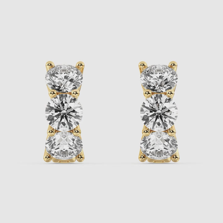 Video showcasing 18K Yellow Gold Huggie Hoop Earrings with 1.38 Ct Round Lab-Grown Diamonds, highlighting their brilliance, sleek design, and secure clasp for a perfect blend of elegance and everyday wearability