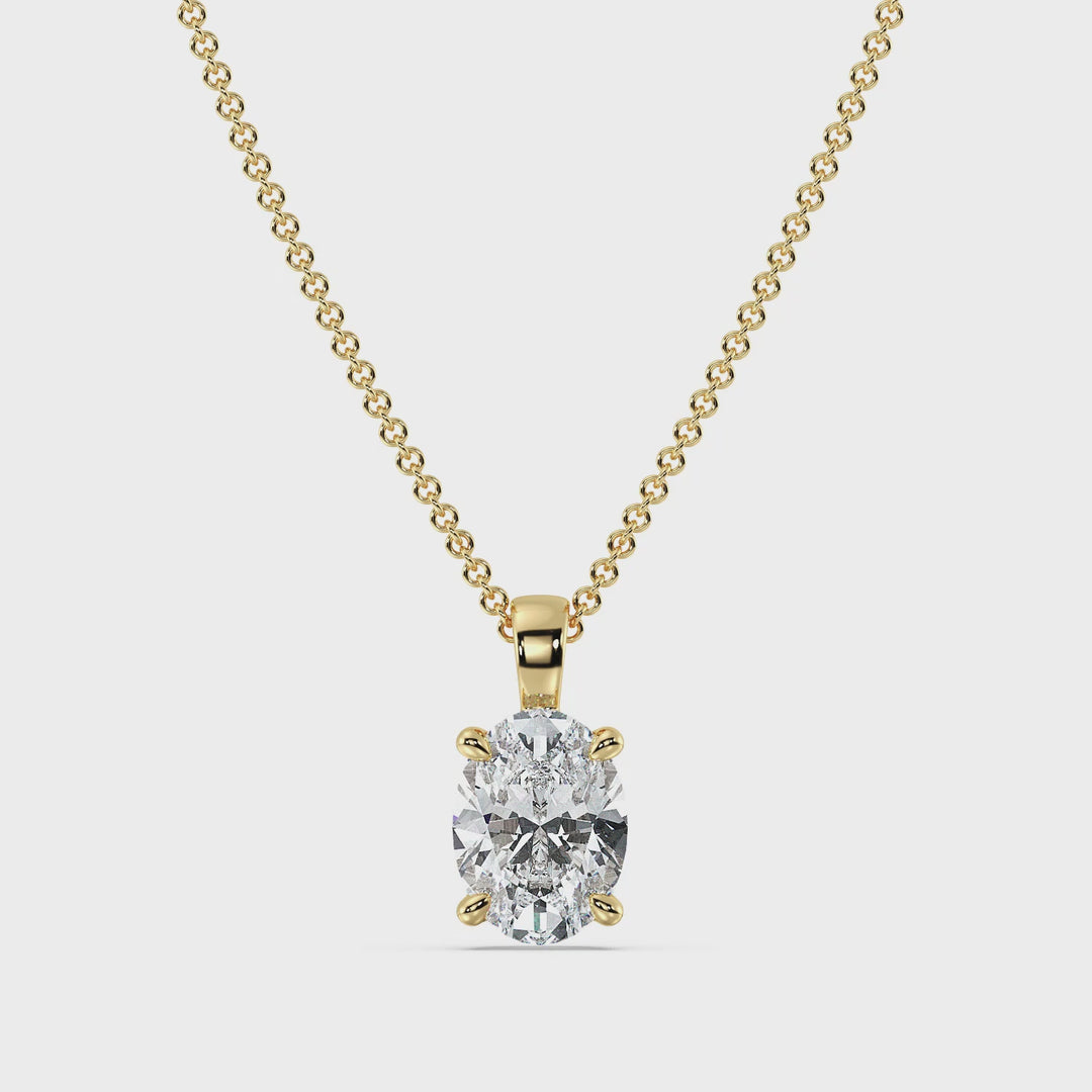 A close-up video showcasing an elegant Oval-Cut Lab-Grown Diamond Solitaire Pendant set in 18K Yellow Gold. The pendant features a radiant oval diamond in a classic 4-claw setting, highlighting its brilliance and clarity. The warm yellow gold enhances the diamond's sparkle, making it a timeless and sophisticated jewelry piece.