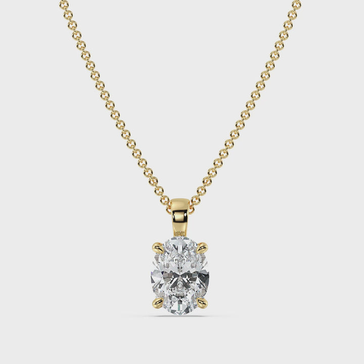 A close-up video showcasing an elegant Oval-Cut Lab-Grown Diamond Solitaire Pendant set in 18K Yellow Gold. The pendant features a radiant oval diamond in a classic 4-claw setting, highlighting its brilliance and clarity. The warm yellow gold enhances the diamond's sparkle, making it a timeless and sophisticated jewelry piece.
