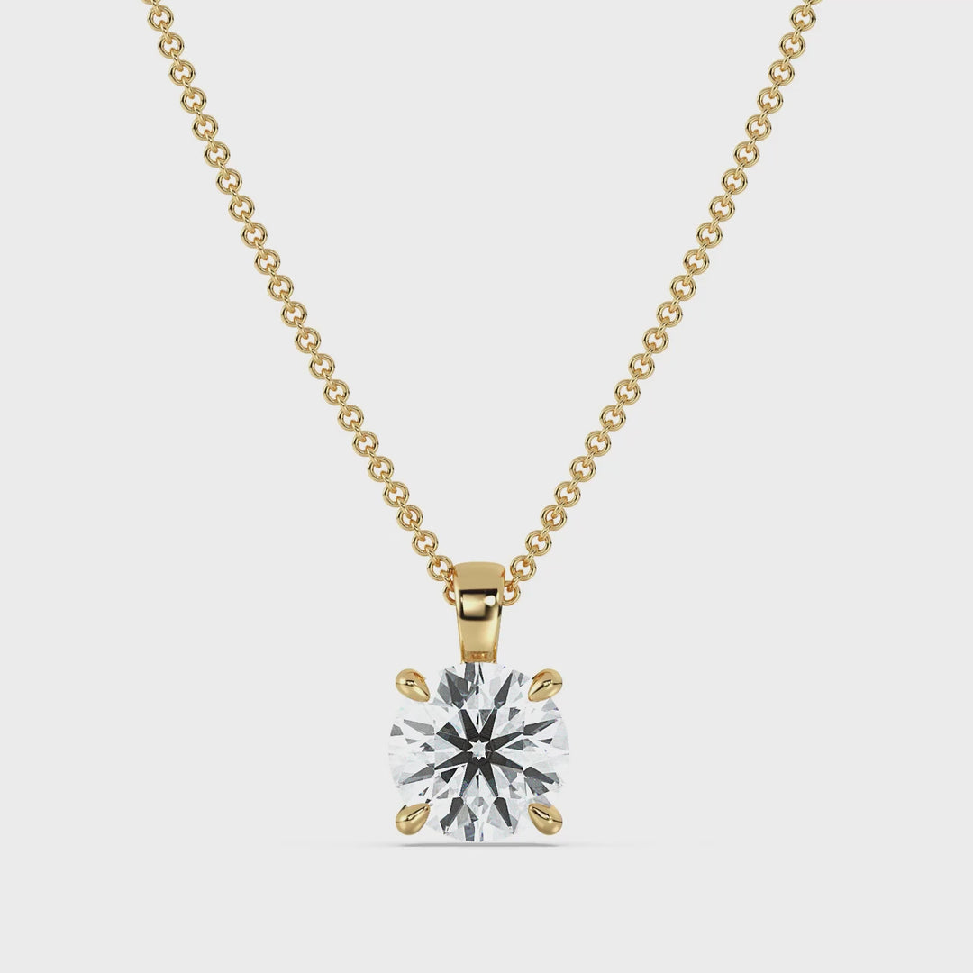 Round-Cut Lab-Grown Diamond Solitaire Pendant in 18K Yellow Gold showcased in a classic 4-claw prong setting, highlighting the diamond's brilliance and timeless elegance. The pendant rotates to display its radiant design from all angles. Chain not included.