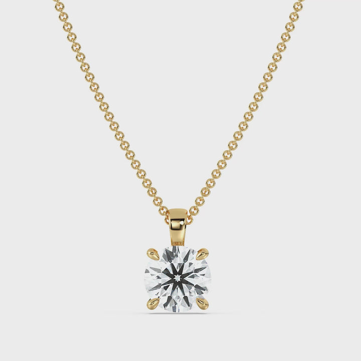 Round-Cut Lab-Grown Diamond Solitaire Pendant in 18K Yellow Gold showcased in a classic 4-claw prong setting, highlighting the diamond's brilliance and timeless elegance. The pendant rotates to display its radiant design from all angles. Chain not included.