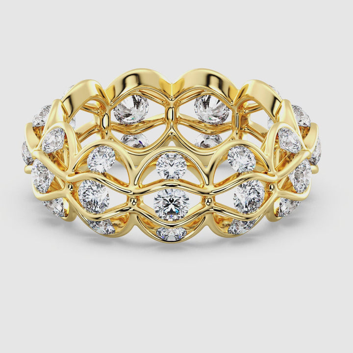 Close-up video showcasing the Marquise Wavy Eternity Wedding Band in yellow gold, featuring 33 sparkling round lab-grown diamonds totaling 2.72 carats. The intricate wavy design highlights the brilliance of the diamonds, set in lustrous 18K yellow gold, capturing timeless elegance and modern sophistication